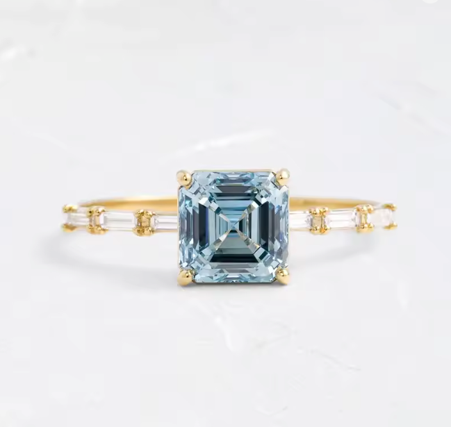 asscher cut blue lab-grown diamond ring in 9k yellow gold – 2.0 ct with baguette side diamonds
