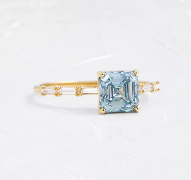 asscher cut blue lab-grown diamond ring in 9k yellow gold – 2.0 ct with baguette side diamonds