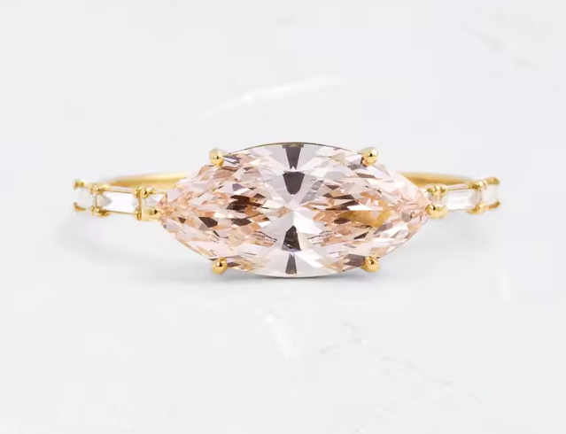 east-west marquise cut pink lab-grown diamond 1.5ct ring in 9k yellow gold with baguette side diamonds
